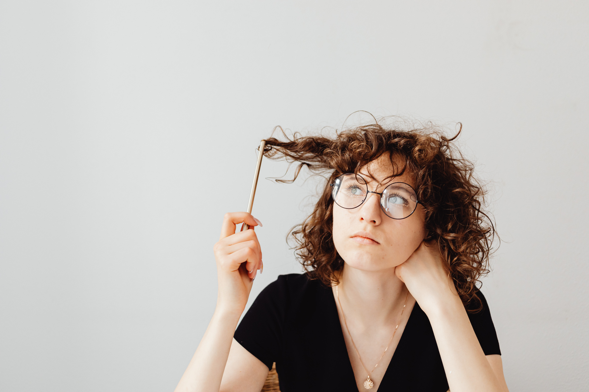 Woman in Black V-Neck Shirt Wearing Eyeglasses
